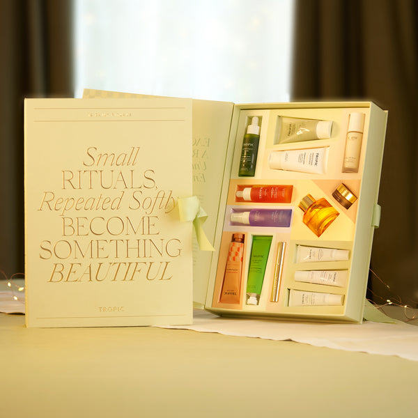 Tropic advent calendar open showing 24 numbered drawers with gold foil detailing on a grey background.