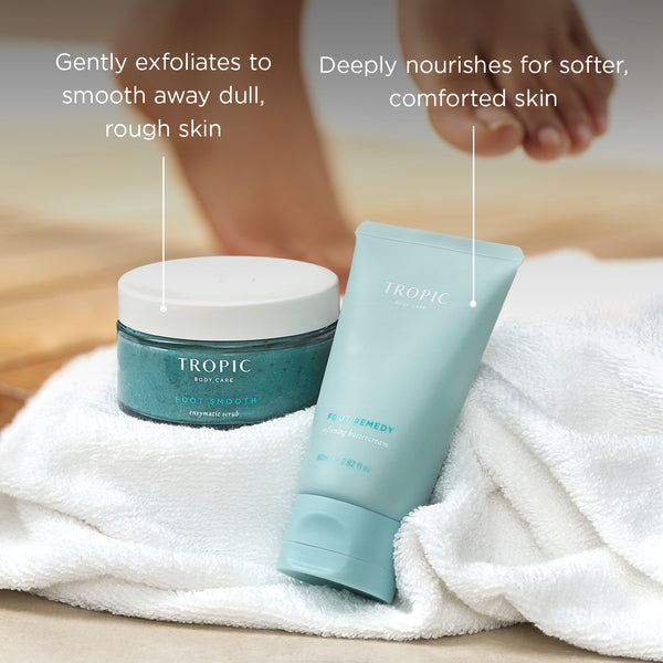 Tropic Foot Smooth Enzymatic Scrub and Foot Remedy Softening Buttercream displayed on a white towel with on-image text highlighting gentle exfoliation and deep nourishment for softer, comforted feet.