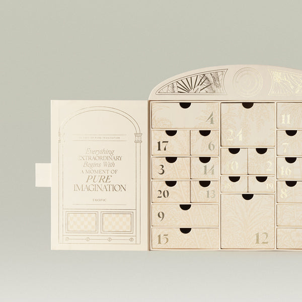 Tropic advent calendar open showing 24 numbered drawers with botanical detailing beside the lid reading 