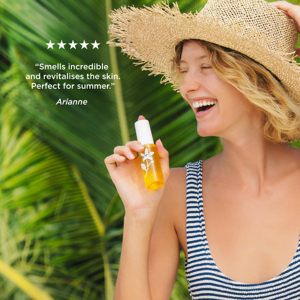 Person holding Tropic Summer Spritz Refreshing Facial Mist with five-star customer review: 