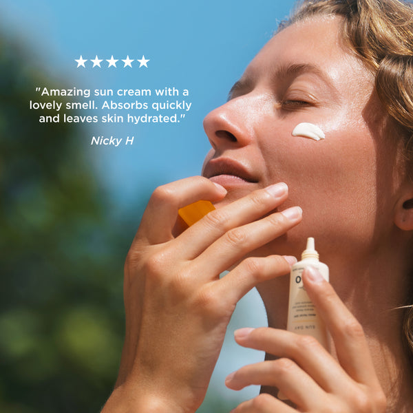 Person applying Tropic Sun Day SPF 50 facial sunscreen with five-star customer review: 