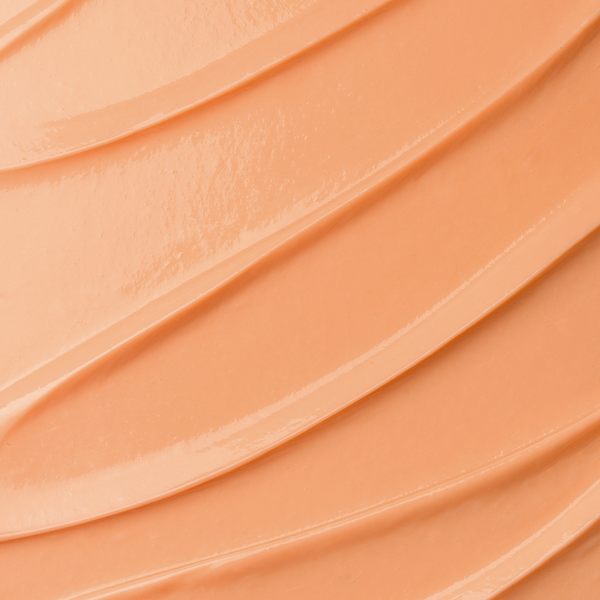 Close-up texture swatch of Skin Dream Advanced Firming Night Cream, showing a rich peach-toned cream.