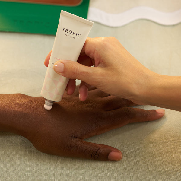 Tropic hand cream being applied to the back of a hand.