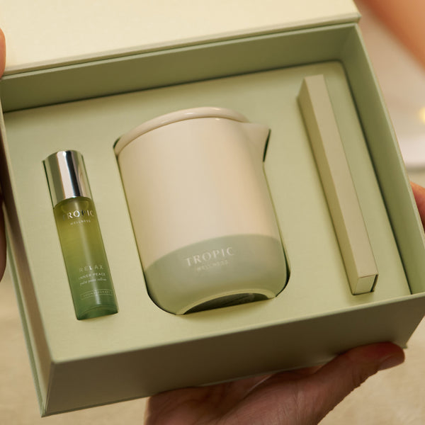 Tropic Wellness gift set open box with Relax Inner Peace pulse point roller and candle.