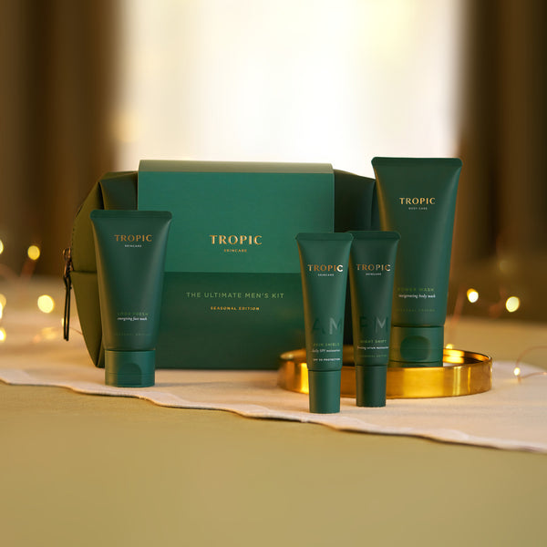 Tropic The Ultimate Men's Kit Seasonal Edition with Look Fresh, Skin Shield, Night Shift and Power Wash beside green gift box and wash bag.