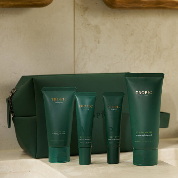 Tropic Made for Men gift set with Look Fresh, Skin Shield, Night Shift and Power Wash tubes displayed in front of a green wash bag.