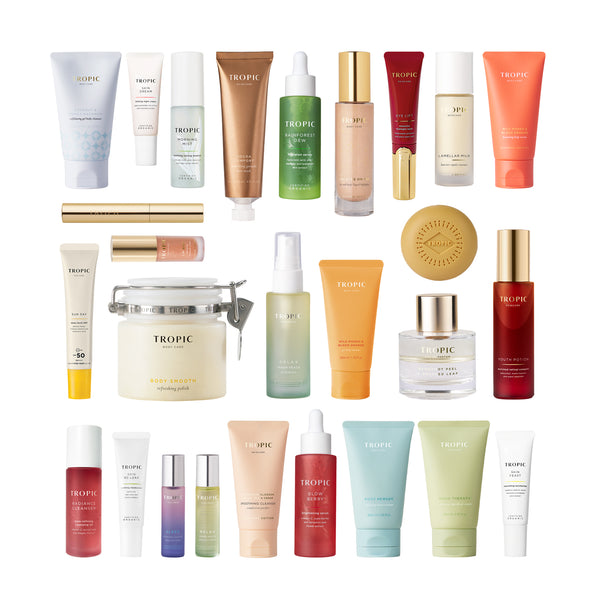 Flat lay of Tropic skincare and body care product range on white background.