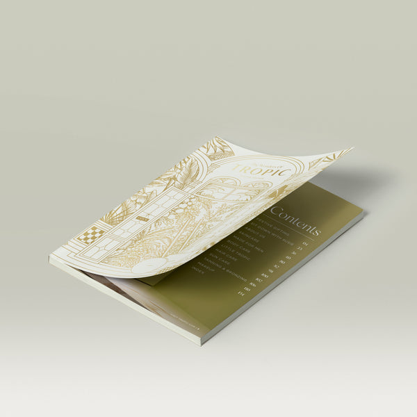 Tropic Beauty Brochure open to the contents page, with gold botanical illustrated cover.