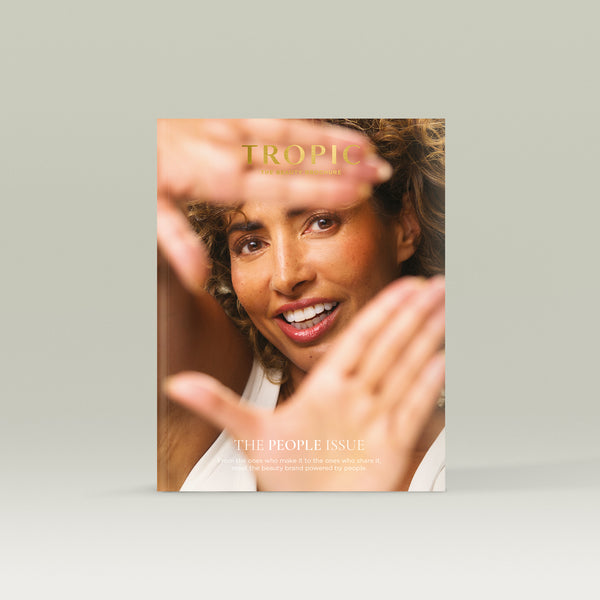 Tropic Beauty Brochure cover featuring a smiling woman framing her face with her hands, highlighting natural beauty and a people-first theme.