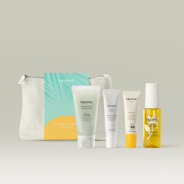 Tropic limited edition Carry-On Collection travel kit with four skincare products and a cotton bag.