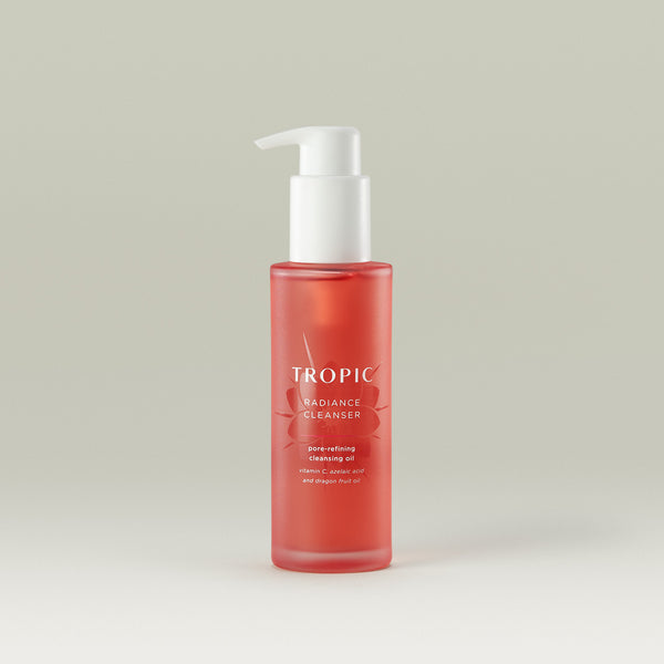 Tropic Radiance Cleanser pore-refining cleansing oil. Contains Vitamin C, azelaic acid and dragon fruit oil.

White pump dispenser. Pink glass bottle with floral embossed design behind white text.