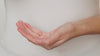 Model shakes clarifying cleanser into the palm of their hands and add a splash of water to activate the product. Next, they Rub together in their hands. They then apply to their face from nose to cheeks rubbing the product into their skin. To remove they use a damp bamboo cloth.