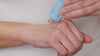 Model  squeezes the new horizons face mask onto the back of her hand revealing its blue thick texture. Using the other hand they apply the mask to their face in the t-zone areas.
