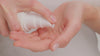 Models pumps smoothing cleanser into the palm of their hands. They then apply to to their nosed spreading across the rest of their face. They rub the product over their eyes and over lips and then remove with a damp bamboo cloth,