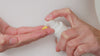 Model pumps Skin Feast moisturiser into the palm of their hands revealing the bright yellow texture of the product. They rub in their hands and then apply the moisturiser to their face and neck.